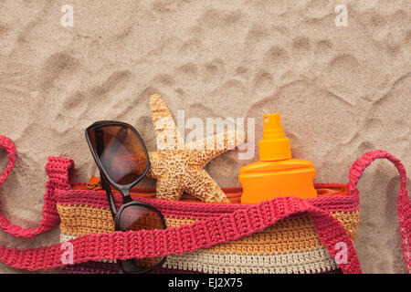 Accessories for the beach lying on the sand, with place for your text Stock Photo