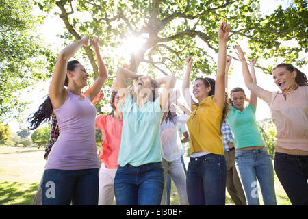 Happy friends in the park cheering Stock Photo