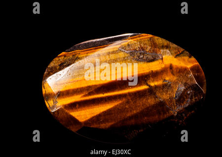 Tiger eye mineral stone in studio setting Stock Photo