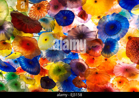 Floral Background of Plastic Multicolored Flowers Backlit Stock Photo