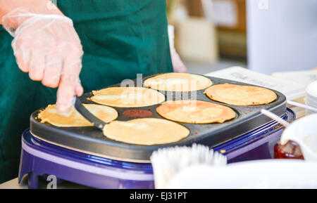 Making Pancakes on a hot griddle Stock Photo