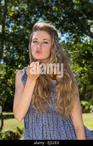 Pretty blonde blowing a kiss Stock Photo