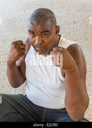 A forty-two year old Afro-Cuban former boxer puts his 'dukes up' in a boxing pose as he looks forward. Stock Photo