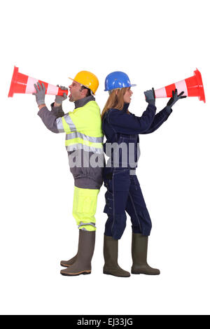 Labourers shouting in traffic cones Stock Photo