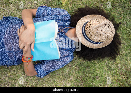 Pretty young woman napping in park Stock Photo