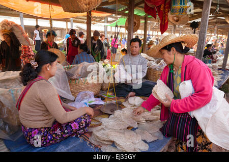 Local burmese woman buying food at a village market, Nam Pan village, Inle Lake, Myanmar ( Burma ), Asia Stock Photo