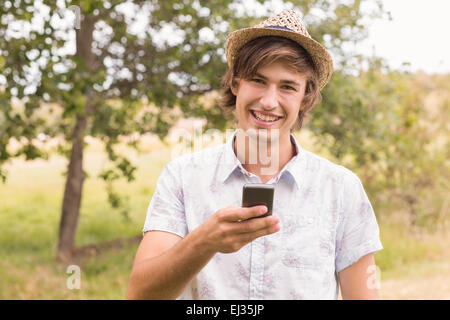 Happy young man using smartphone Stock Photo