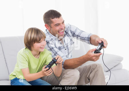 Father and son playing video game Stock Photo