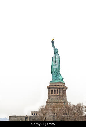 Statue of Liberty National Monument against a stark white sky. Stock Photo