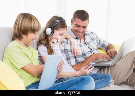 Happy man with children using technologies Stock Photo