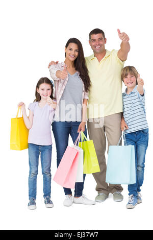 Family with shopping bags gesturing thumbs up Stock Photo
