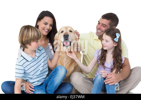 Family stroking dog Stock Photo