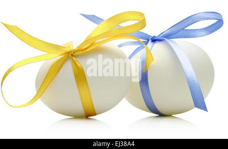 Two Easter eggs with festive blue and yellow bow isolated on white background. Stock Photo
