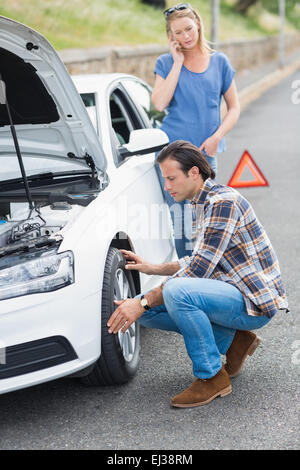 Couple after a car breakdown Stock Photo