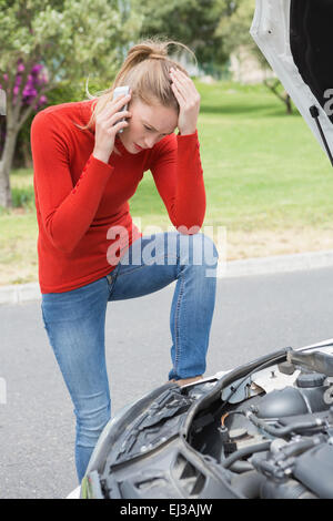 Stressed woman looking at engine Stock Photo