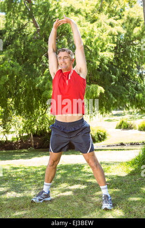 Fit man stretching in the park Stock Photo