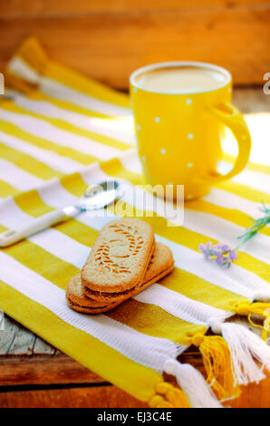 Ginger cinnamon and milk coffee with blooming lavender and sandwich cookies, Ukrainian style Stock Photo