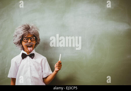 Boy dressed as senior teacher in front of blackboard Stock Photo