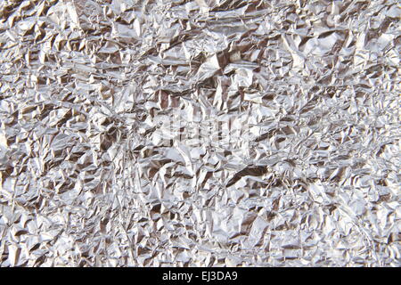 Aluminum foil curled, silver background. Stock Photo