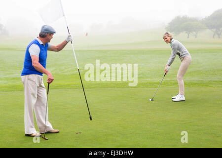 Golfing couple on the golf course Stock Photo