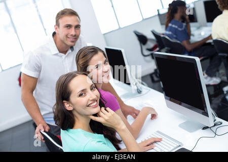 Computer teacher and pretty female students Stock Photo
