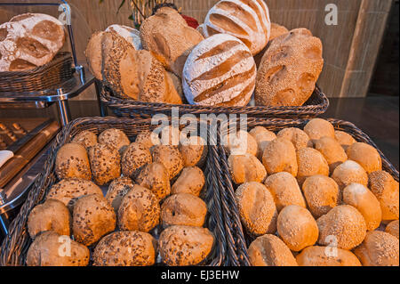 Selection of various breads in baskets at a restaurant breakfast buffet Stock Photo