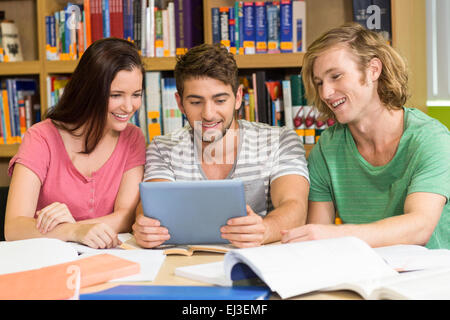 College students using digital tablet in library Stock Photo