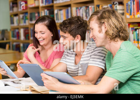 College students using digital tablets in library Stock Photo