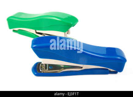 Two green and blue staplers on white background Stock Photo