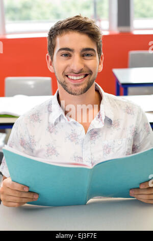 Male student reading notes in classroom Stock Photo