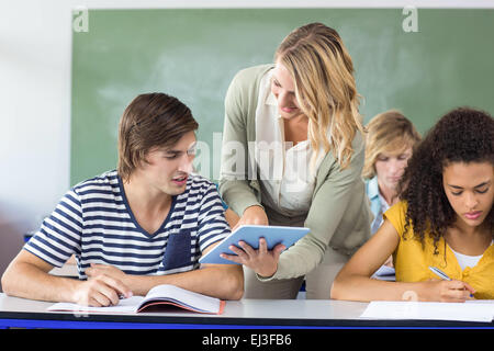 Teacher helping student in class Stock Photo