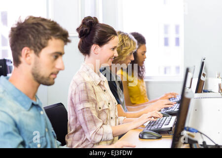 Side view of students in computer class Stock Photo