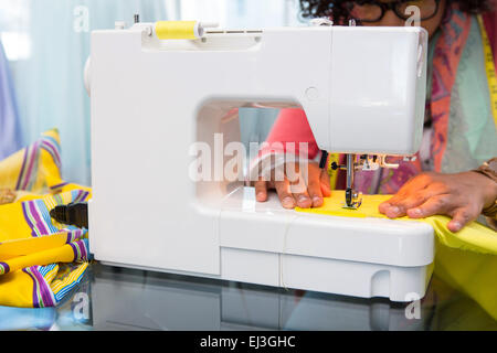 Fashion designer using sewing machine Stock Photo