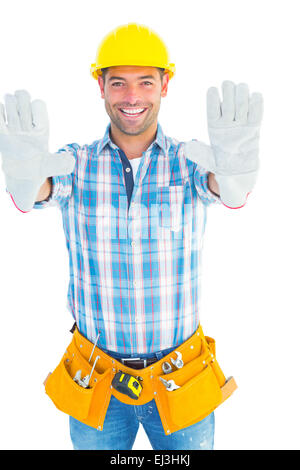 Happy manual worker making stop sign Stock Photo