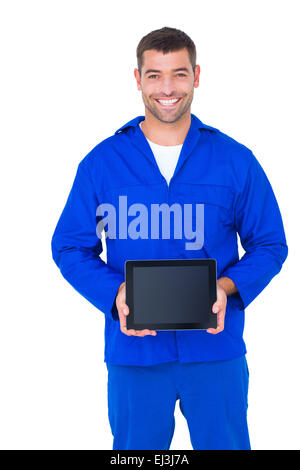 Smiling male mechanic showing digital tablet Stock Photo