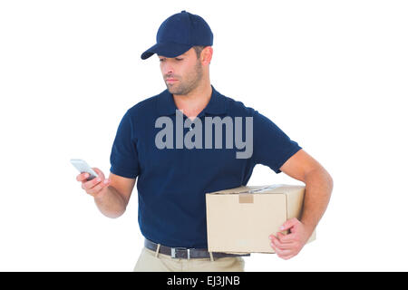 Delivery man using mobile phone while holding package Stock Photo