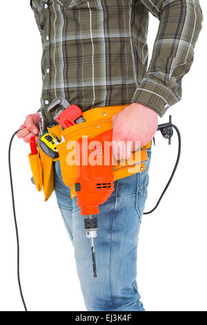 Smiling manual worker holding drill machine Stock Photo