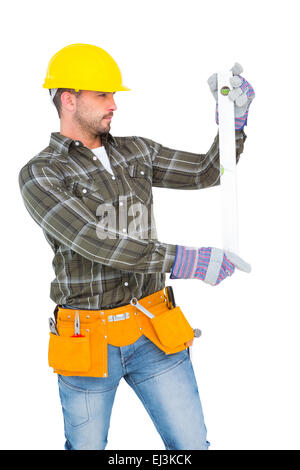 Serious handyman using spirit level Stock Photo