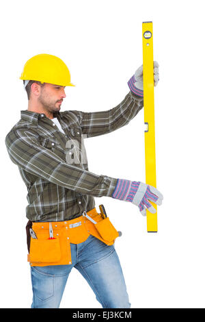 Serious handyman using spirit level Stock Photo