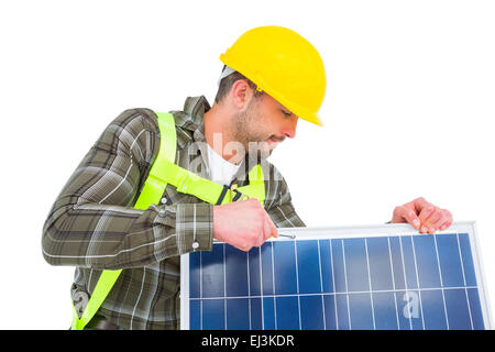 Worker tightening solar panel Stock Photo