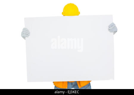 Handyman holding blank placard Stock Photo