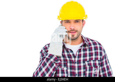 Repairman talking on mobile phone Stock Photo