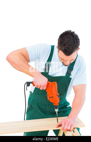 Carpenter drilling hole in plank Stock Photo