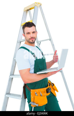 Carpenter using laptop Stock Photo