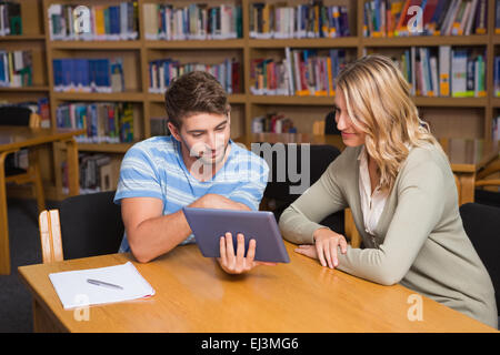 Student getting help from tutor in library Stock Photo