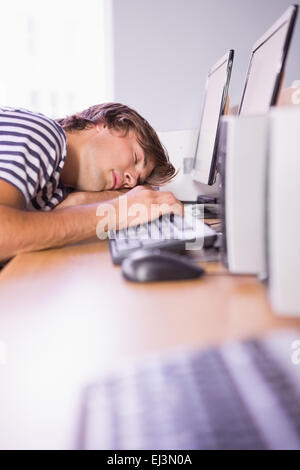 Student sleeping on computer in classroom Stock Photo