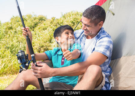 Father and son beside tent Stock Photo