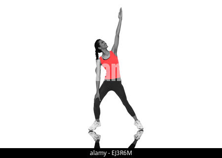 Composite image of full length of a sporty young woman stretching hand Stock Photo