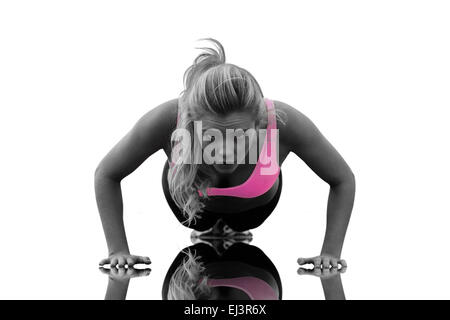 Composite image of beautiful woman doing push ups on beach Stock Photo