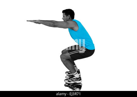 Composite image of side view of a fit young man doing stretching exercise Stock Photo